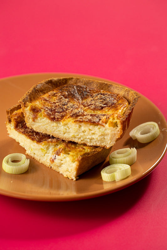 Quiche de queijo cortada, em close, mostrando o recheio de alho-poró
